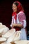 Woman selling wood plates at a traditional fair