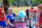 A woman sells cotton candy to a teenager on the street in the autumn Park