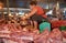 Woman sells raw meat at the central market