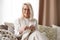 Woman Senior Adult Knitting Concept - Elderly blond woman holding knitting needles