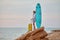 Woman with sense of adventure with surfboard and suitcase. Surfing time, relaxation and summer holiday idea. Copy space