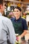 Woman serving customer in florist