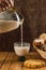 Woman serving glass of milk from a jug. Bread basket, typical of the peoples of Mexico, with sweet bread