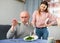 Woman serving salad for her displeased husband