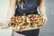 Woman serving vegan barbecue skewers on a wooden board