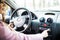 Woman set up music in car. Car dashboard. Radio closeup. Woman sets up radio