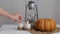 Woman sets fire to a match with a match near a pumpkin and a lantern