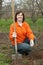 Woman sets tree in garden