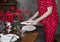 Woman setting, serving and decorating holiday dining table with napkin and plates for Christmas dinner