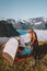 Woman setting up tent camping gear in mountains travel lifestyle vacations outdoor, traveler girl hiking in Norway