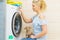 Woman setting washing machine