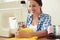 Woman sewing yellow dress