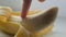 Woman sexually touching with a finger of purified banana, macro close up view