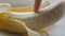 Woman sexually touching with a finger of purified banana, macro close up view