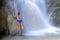 Woman sexy enjoy in waterfall with bikini