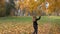 Woman shake autumn tree