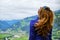 Woman shakes her brown, curly hair, during a hike above Zillertal valley, Austria