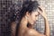 Woman shampooing her long brown hair