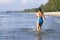 Woman shape beautiful and bikini blue jump on wave at beach
