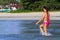 Woman shape beautiul walk on beach with pink bikini