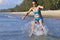 Woman shape pretty and bikini blue jump on wave at beach