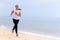 Woman shape pretty morning running on beach