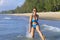 Woman shape sexy with bikini blue jump on wave at beach