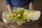 Woman shares the Chinese cabbage into two halves on the board