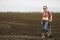 Woman with sharp shovel and cultivated field