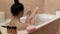 Woman shaving her legs in bath