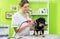 Woman is shearing dog in pet grooming parlor