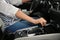 Woman shifting gears in car, closeup.