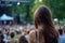 woman with shiny locks attending outdoor concert