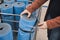 Woman in a shop chooses a blue travel, sports mat to buy. Hands close up shot