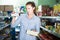 Woman in the shop holding preserved of tuna