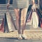 Woman with shopping bags against a mall steps