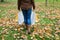 Woman with shopping bags walking along autumn park