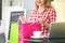 Woman in shopping center with bags. Fashion girl in mall looking surprised on shopwindow background