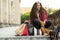 Woman shopping in the city with four Dachshund dogs