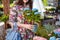 Woman shopping for flowers in garden centre variation of plants