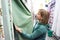 Woman shopping green blinds in DIY shop