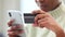 Woman shopping online using her credit card and phone, using a banking app for secure payment for her internet order