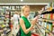 Woman shopping personal hygiene products at supermarket.