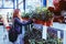 Woman shopping for potted flowers in a gardening market