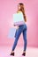 Woman with shopping purchase, paper bag and happy with retail on pink background. Happiness, customer experience with