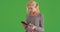 Woman shopping at supermarket, checking nutrition facts on green screen