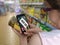 Woman is shopping in supermarket and scanning barcode with smartphone in grocery store.