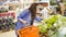 Woman shopping in supermarket. young woman picking up, choosing green leafy salad in grocery store. healthy life style