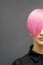 Woman with short bright pink hair