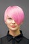 Woman with short bright pink hair